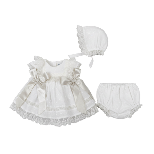 White baby dress with bonnet and bloomers on a white background