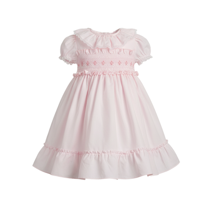 Pink dress with ruffled sleeves and neckline on a white background