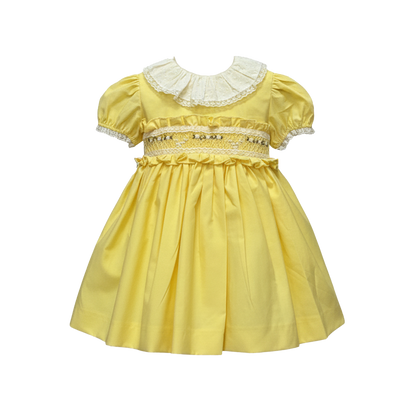 Yellow dress with lace details on a white background