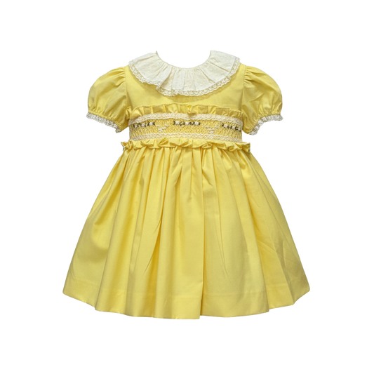 Yellow dress with lace details on a white background